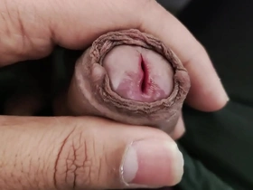 An Asian boy playing with his genitals.
