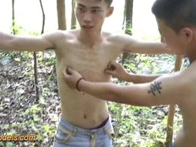 Tiny Asian guy tied up in the woods for BDSM fun